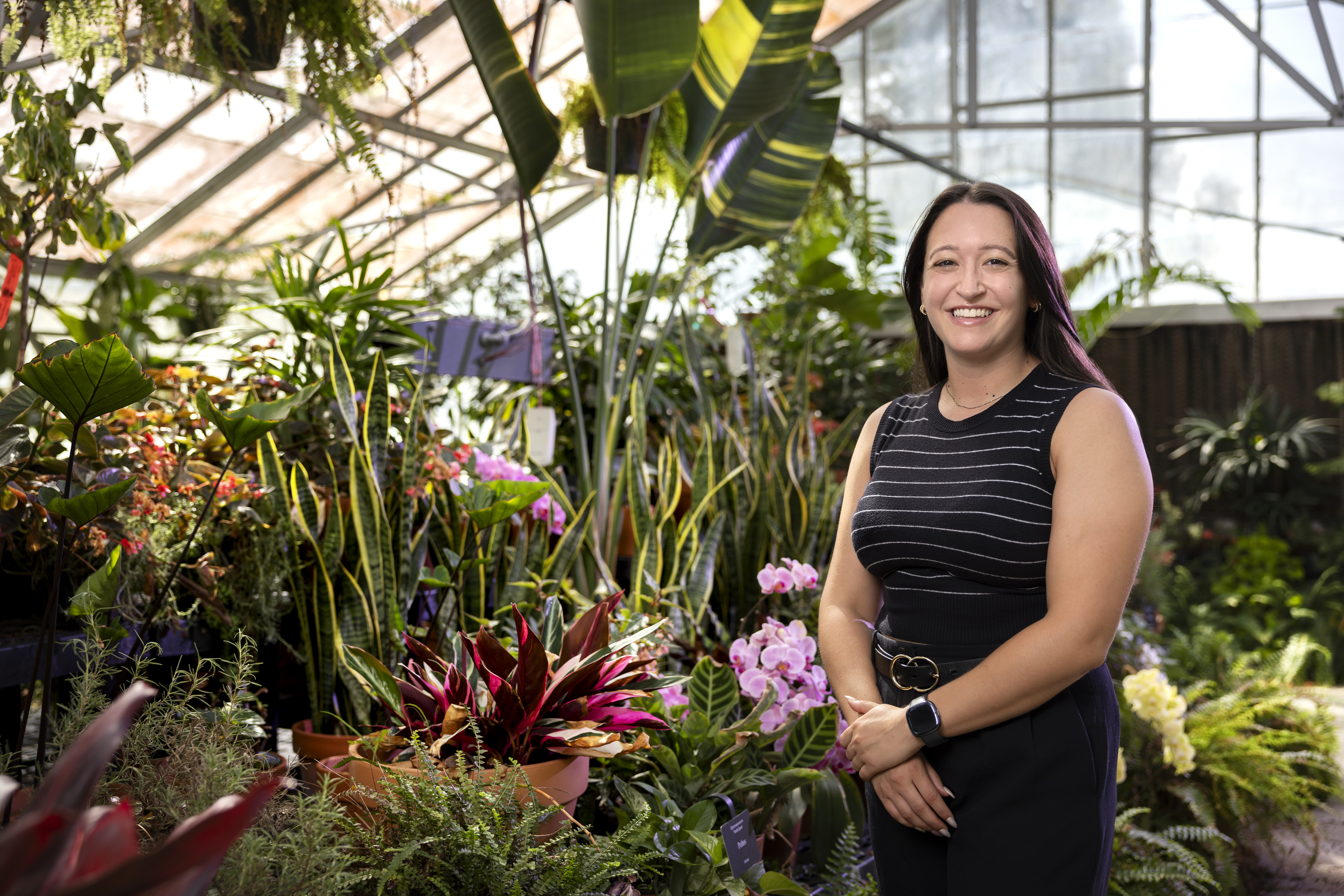 Assistant Professor Morgan Christman standing in front of flowers