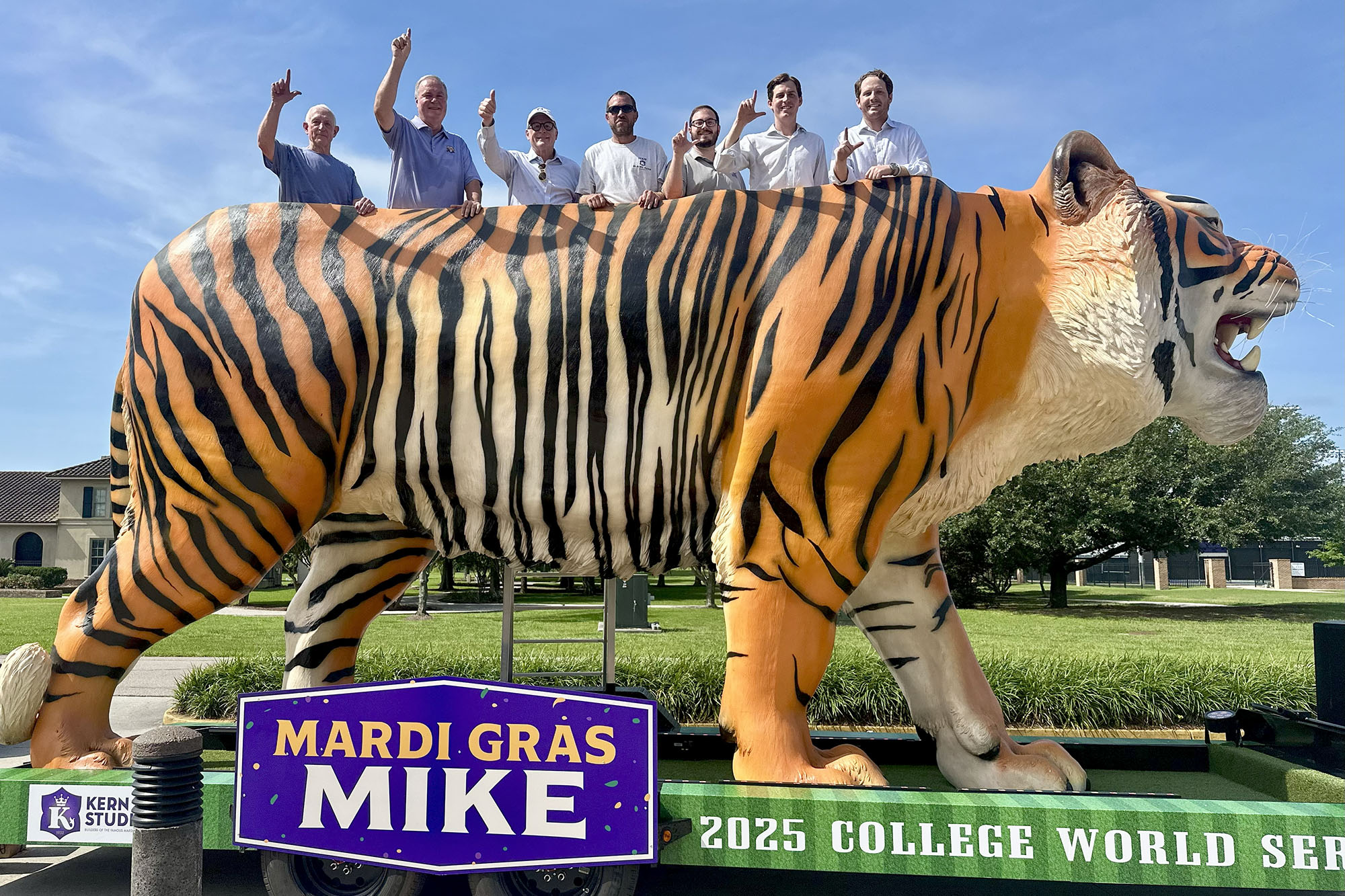 People pose atop 30-foot tiger sculpture