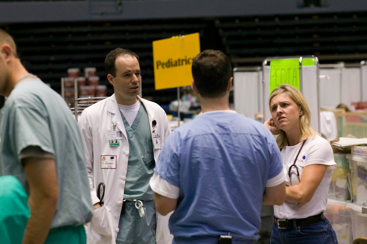 Medical workers consult inside the field hospital at LSU's Pete Maravich Assembly Center
