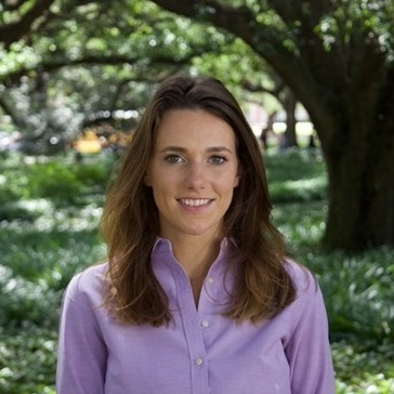 smiling woman in purple polo