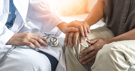 Healthcare professional providing support to an older adult.