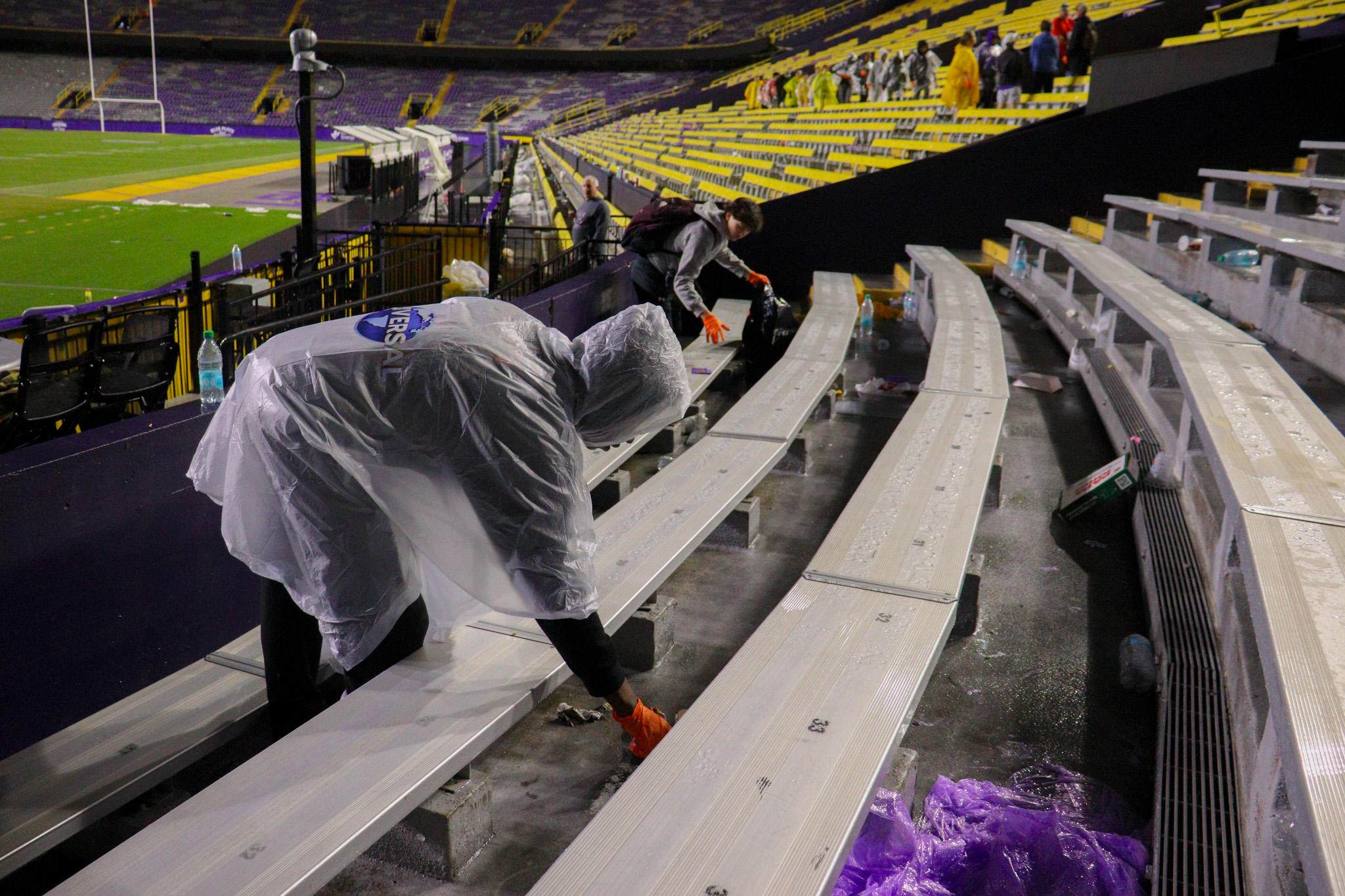 A person pickup waste in Tiger Stadium.